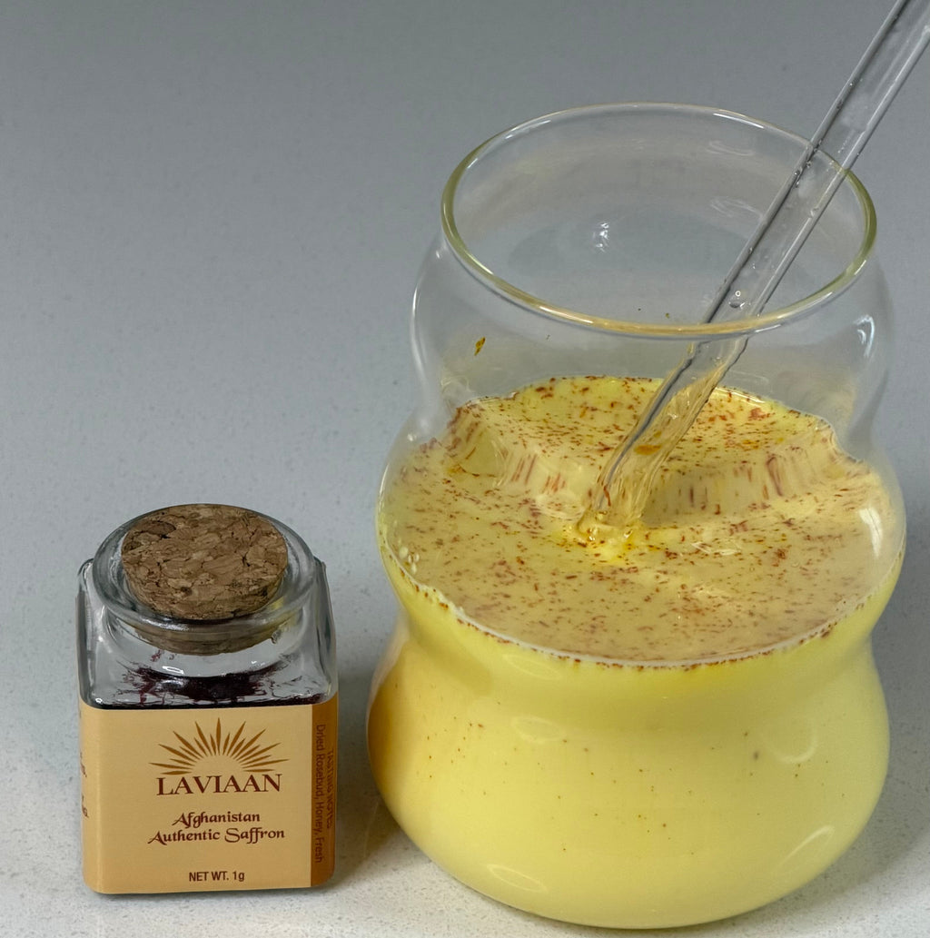 Jar of yellow powder with a spoon and a small container labeled 'Lavish' on a gray background