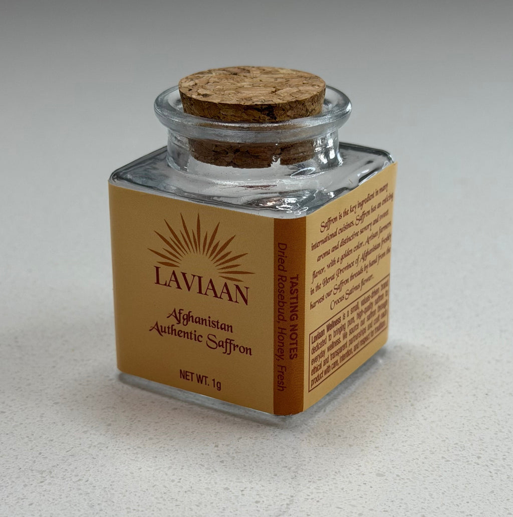 Small glass jar with cork lid on a textured gray surface