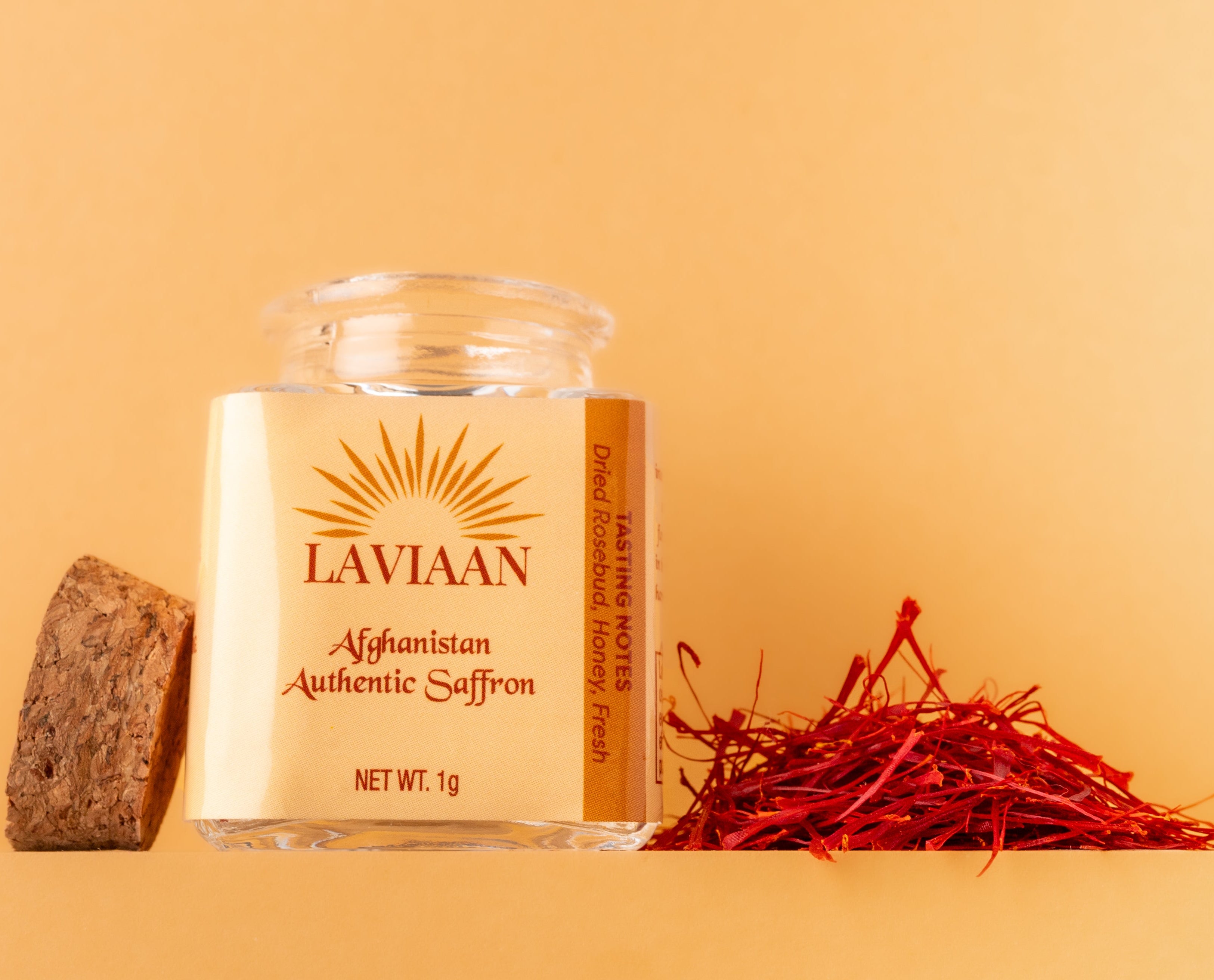 Lavivaan Afghanian Saffron jar with saffron strands on a beige background
