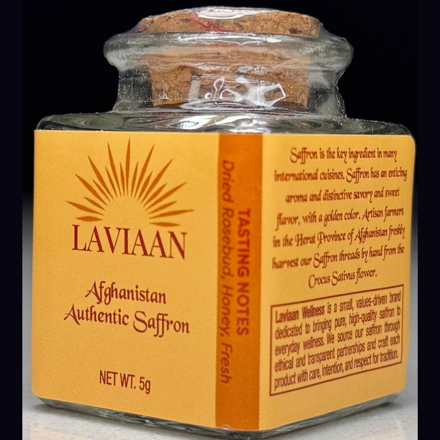 Laviaan Afghan saffron jar with orange label on a dark background