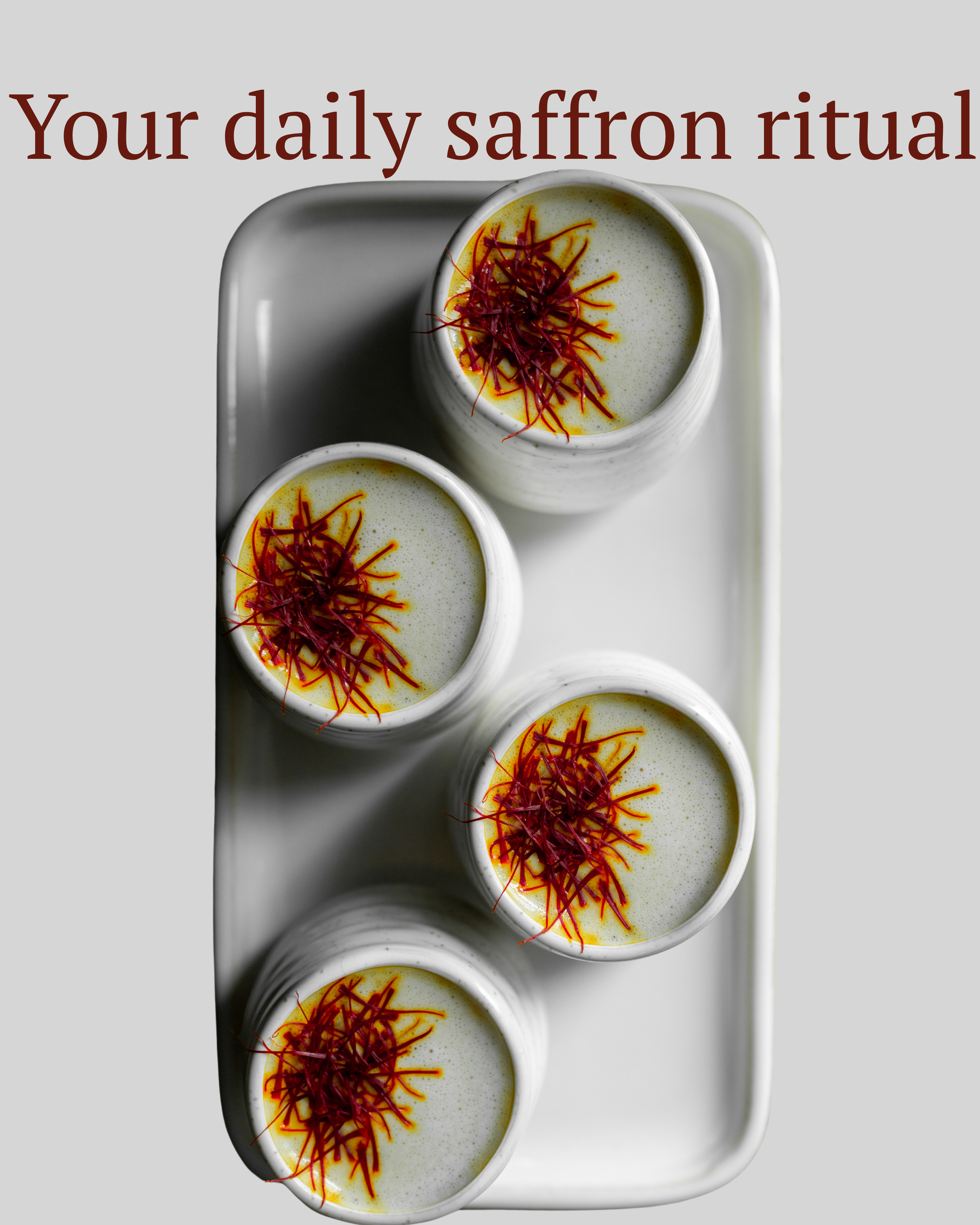 Four white cups with saffron on a gray tray, text 'Your daily saffron ritual' above.